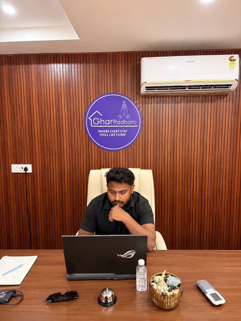 GharPadharo team member working at desk with laptop