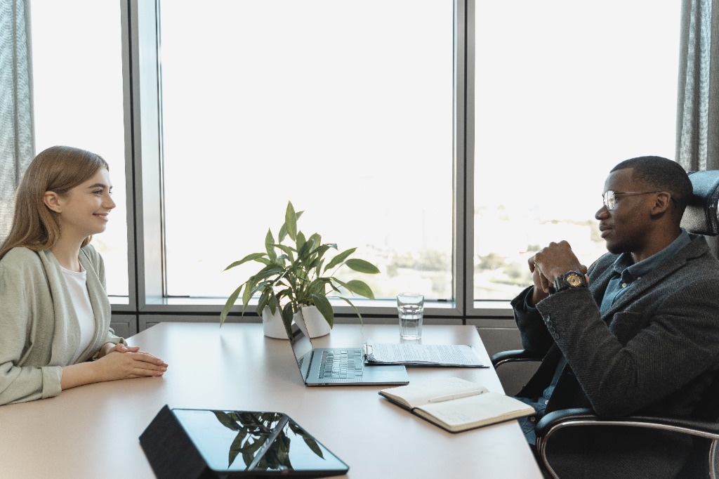 Professionals having a conversation across a desk